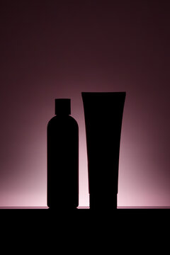 Silhouetted shampoo bottle and conditioner tube set
