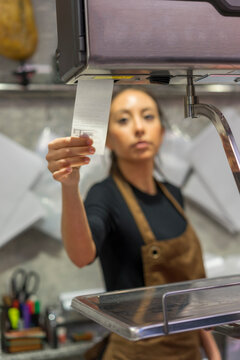 Female butcher with sales slip