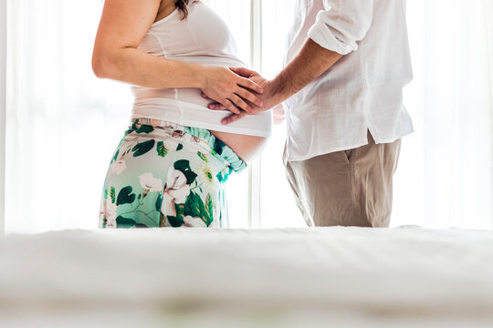 Man touching belly of pregnant woman