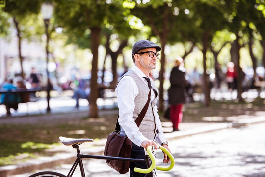Mature businessman on bicycle in the city