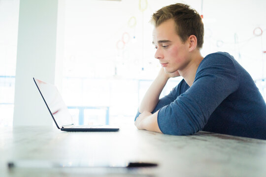 Worried student looking at laptop