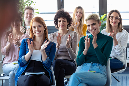Businesswomen clapping hands during a training