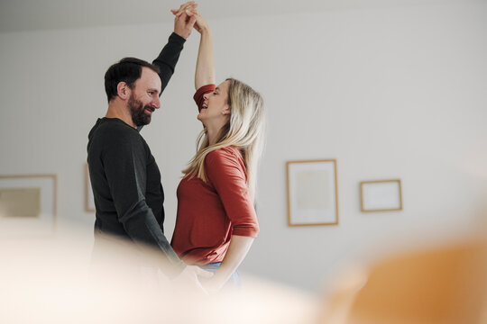 Happy couple dancing at home