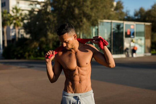 Portrait of a muscular man with bare chest, after workout