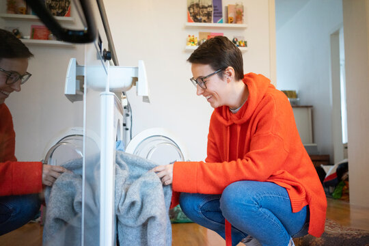 Young woman doing the laundry at home