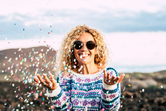 Portrait of happy blond woman celebrating with confetti, Tenerife, Spain