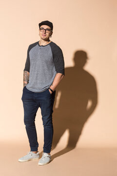 Portrait of tattooed mature man wearing basecap and glasses