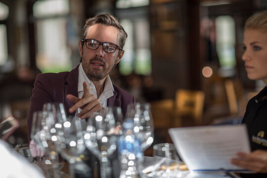 Man talking to waitress in restaurant
