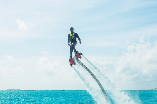 Maldives, man on flyboard above the sea