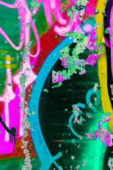Weathered concrete wall covered in neon pink and green spray paint. Peeling paint layers create a distressed urban texture for gritty street art designs and streetwear branding. © Aleksandra Konoplya