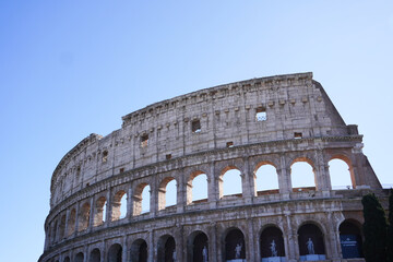 Fototapeta premium Colosseum (Coliseum) building or Flavian Amphitheatre in Rome, Lazio, Italy. Architectural monument of Ancient Rome. Close up view of the Colosseum, highlighting arches and aged stone. 