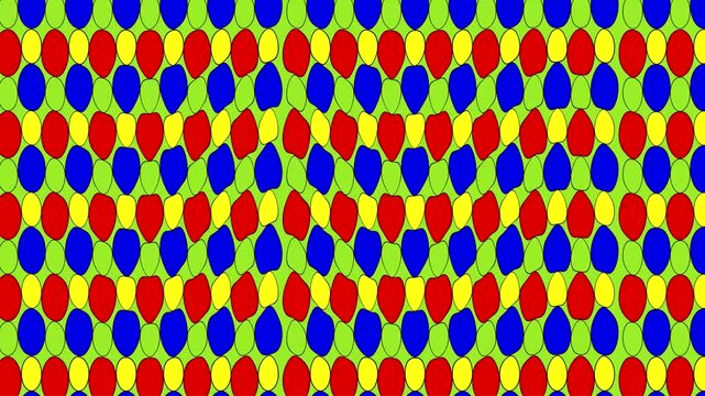 Colorful pattern of shapes in red, blue, yellow, and green in a repeating design on a flat surface