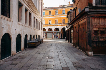 Fototapeta premium Street view in an old town with shops and empty benches in the morning light