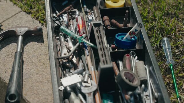 Open toolbox filled with screwdrivers sockets and repair tools