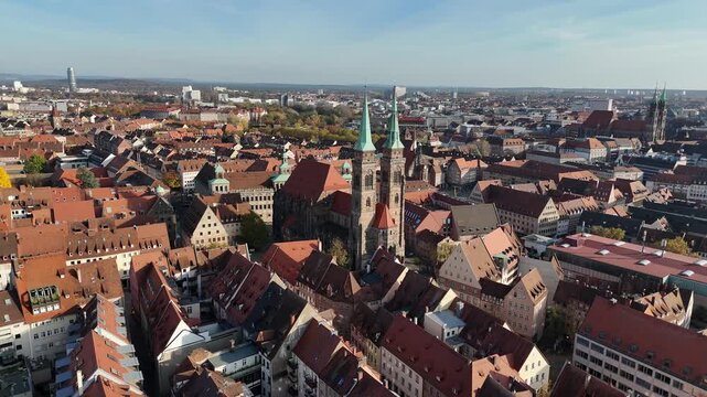Drone makes a circular move around St Sebald Church from above with dense old town blocks surrounding it