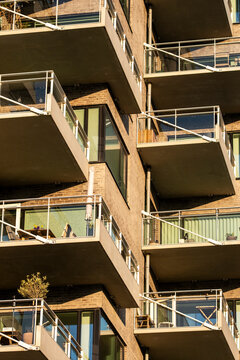 Stacked balconies on modern Copenhagen apartment building create facade pattern repetition in residential architecture for property and real estate visuals