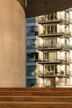 Modern apartment building architecture in Copenhagen with residential balconies steps and facade detail in urban setting for real estate development concept