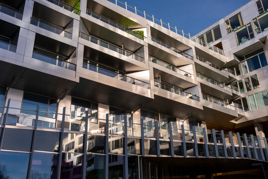 Contemporary apartment building in urban Copenhagen showing modern residential facade with glass balconies and architecture details for real estate buyers