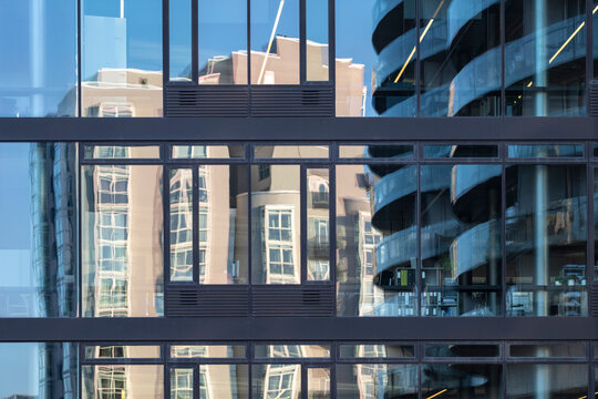 Modern glass windows with reflection on Copenhagen building facade showing urban office architecture pattern and city atmosphere for commercial property use