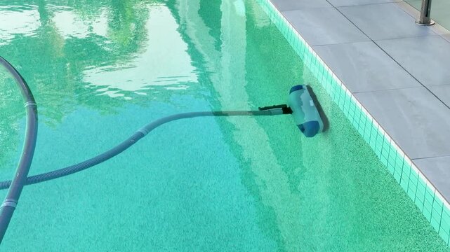Automatic Robotic Pool Cleaner Scrubbing the Wall of a Swimming Pool