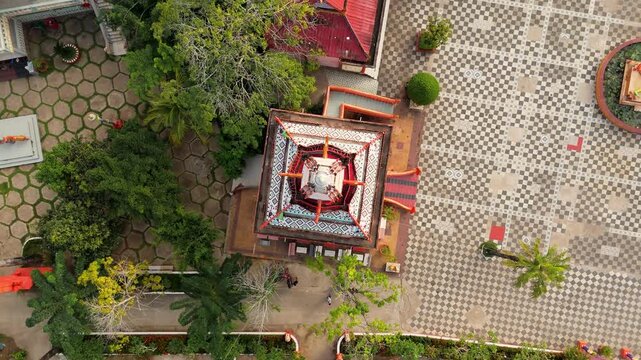 Aerial drone shot of Great Temple Thanh That Cao Dai and large patterned Great Courtyard San Dai Dong Xa showing religious architecture and cultural landmark in Tay Ninh Vietnam