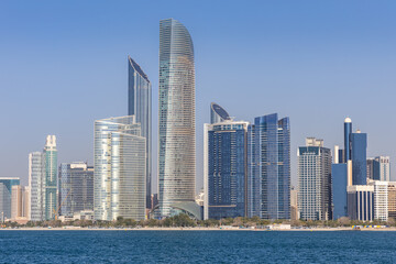 Fototapeta premium Abu Dhabi skyline with skyscrapers at sea in Abu Dhabi, United Arab Emirates