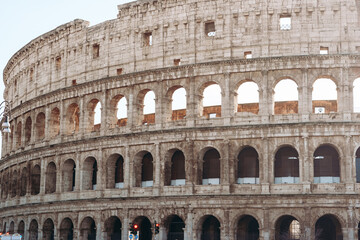 Fototapeta premium Colosseum in Rome shows the ancient structure and history at midday under sunlight