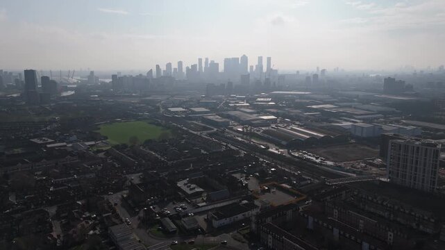 Wide aerial of Canary Wharf skyline in London on a hazy day from West Ham