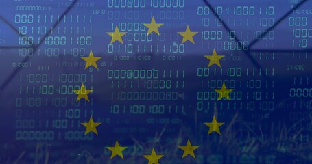 Fototapeta premium Displaying circle of 12 yellow stars over cyan binary digits on blue field, fence silhouette, grass