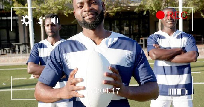 REC indicator flashing as camera pulling back, lead player holding rugby ball smiling to show unity
