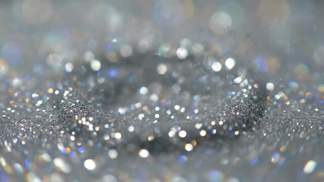 Abstract glitter silver background with bokeh lights sparkles and shiny particles.