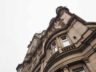 Naklejka premium Ornate Victorian stone building facade and classical architecture in Edinburgh, Scotland, UK with dramatic upward perspective