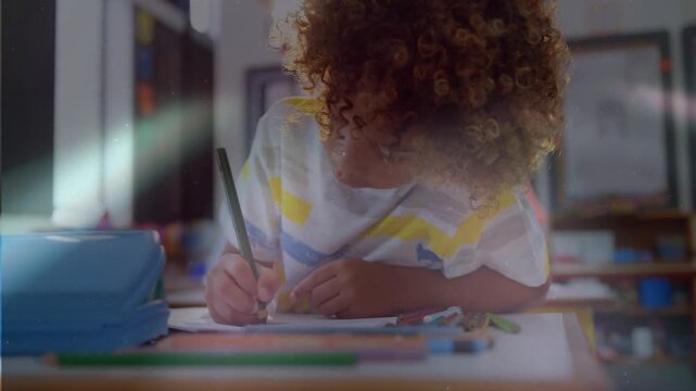 Male student school starting worksheet making pencil marks while light flares sweeping by blue case
