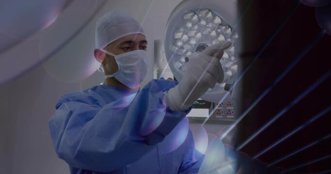 Surgeon reaching toward surgical lamp, adjusting light preop while radial overlay marks controls