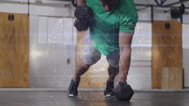 Man starting plank pushing to 1-arm rows with DBs, holo overlay over torso showing core fitness