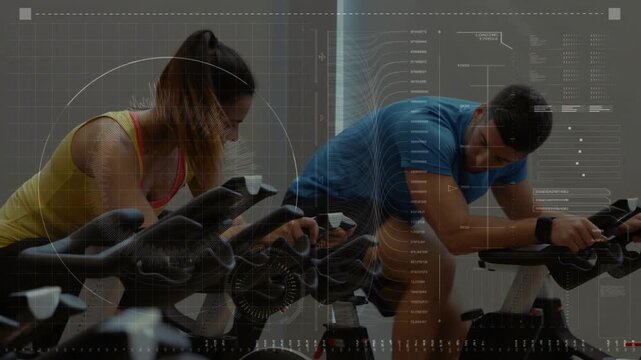 Vertical video: Cycling woman in yellow top and partner starting on bikes at gym, checking console