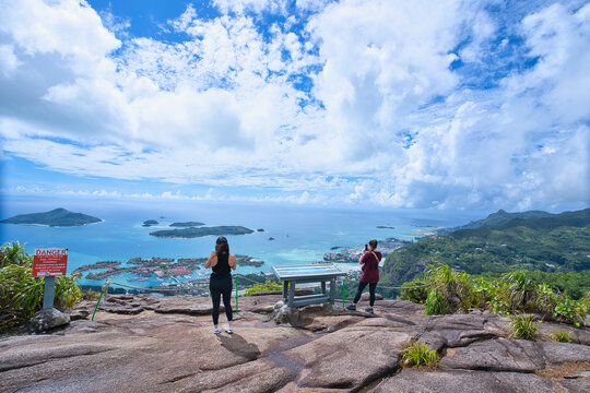 2 woman walking to the breathtaking view point of the Copolia nature trail inside the national park, Mahe Seychelles.