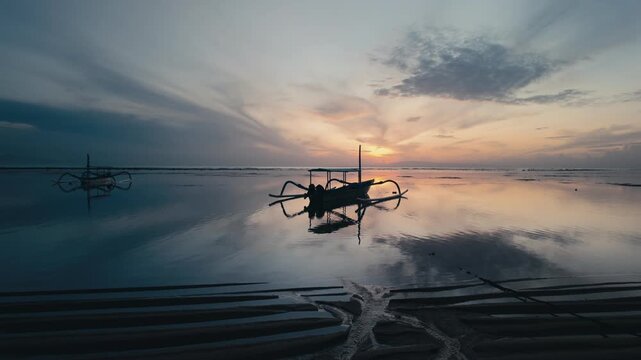 Serene Tropical Beach Landscapes with Traditional Jukung Boats at Sunrise and Sunset