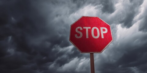 The Stop Sign Standing Against Dramatic Storm Clouds at Dusk on Empty Road