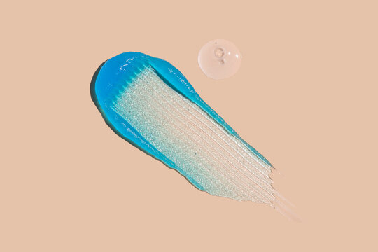 Blue skincare gel and serum swatch with copy space on beige background