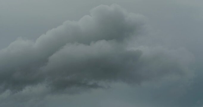 Dark storm clouds forming in grey sky