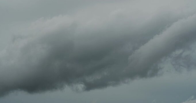 Dark storm clouds forming in grey sky