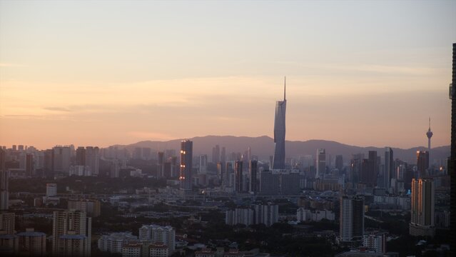 Kuala lumpur skyline illustrating a sprawling city, modern skyscrapers, and urban landscape at sunset, emphasizing economic growth, travel, and malaysian development