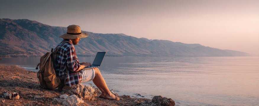 The Woman Working Remotely on Laptop by Seaside at Sunset