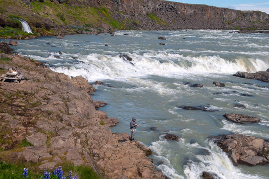 Urridafoss waterfall Iceland, view along the pjorsa river with people fishing