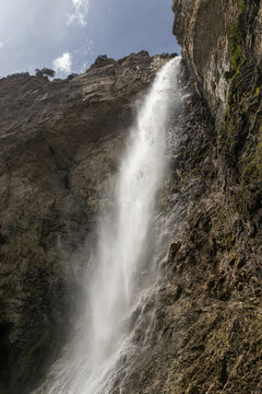 The beautiful 90m high waterfall of Cascade Saint Benoit, near Aussois, Modane, in Savoie, France. The waterfall is a popular tourist spot in the French Alps.