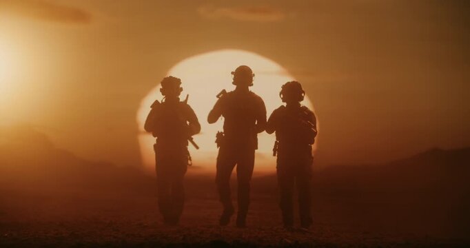 Three Male Soldiers in Advanced Combat Gear March Across a Desert Warzone, Silhouette by a Massive Air Force Formation of Helicopters. Patrol With Rifles, Helmets,  Modern Military Battlefield