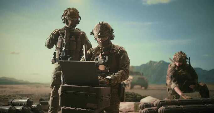 Special Forces Operators Configure Reconnaissance and Surveillance Systems on a Desert Base. Managing Computer that Provides Cyber Security, Battlefield Analysism, Communications, Tactical Warfare