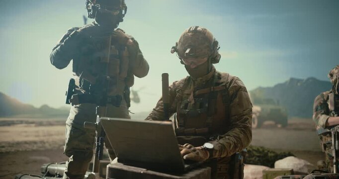 Special Forces Operators Using Laptop for Target Surveillance, Geolocation, Strike Coordination While a Helicopter and Armored Vehicle Support the Mission in a Middle East Combat War Military