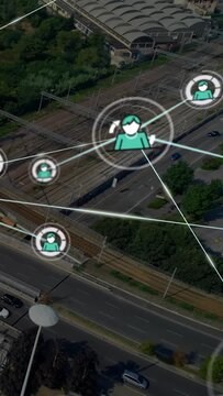 Vertical video: Appearing teal nodes network pulsing and linking over road and rail, showing links